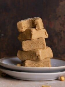 Stack of Old Fashioned Peanut Butter Fudge with bite taken out of top piece