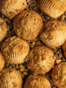 Close up of Pistachio Muffins surrounded by shelled pistachios