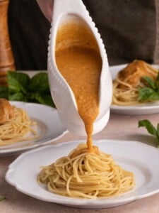 Pouring Sweet Potato Pasta Sauce onto spaghetti
