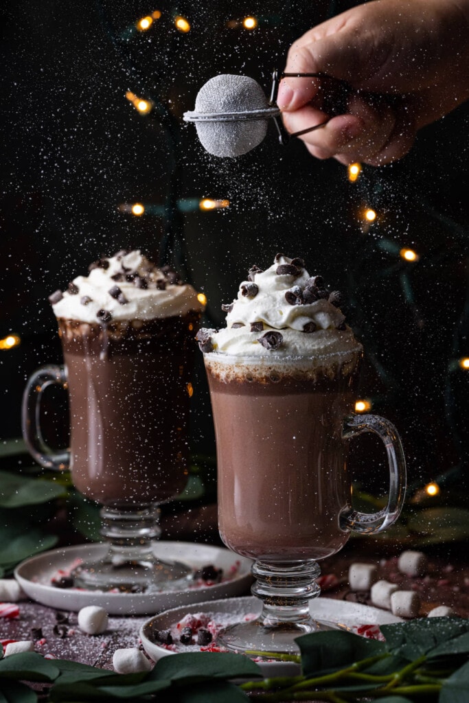 Dusting Baileys Hot Chocolate with powdered sugar