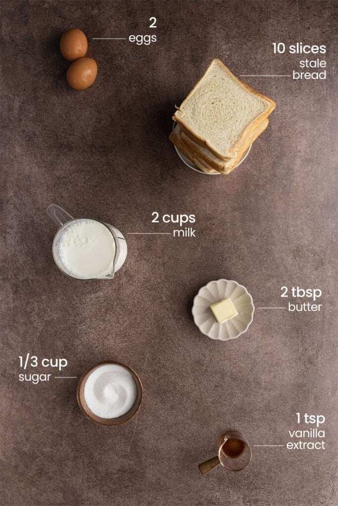 Ingredients for a simple bread pudding, including eggs, stale bread, milk, butter, sugar, vanilla extract.