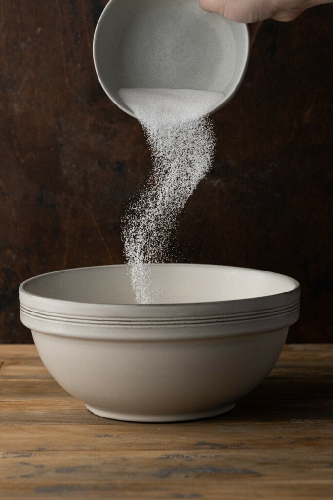 Adding sugar to bread pudding mixture