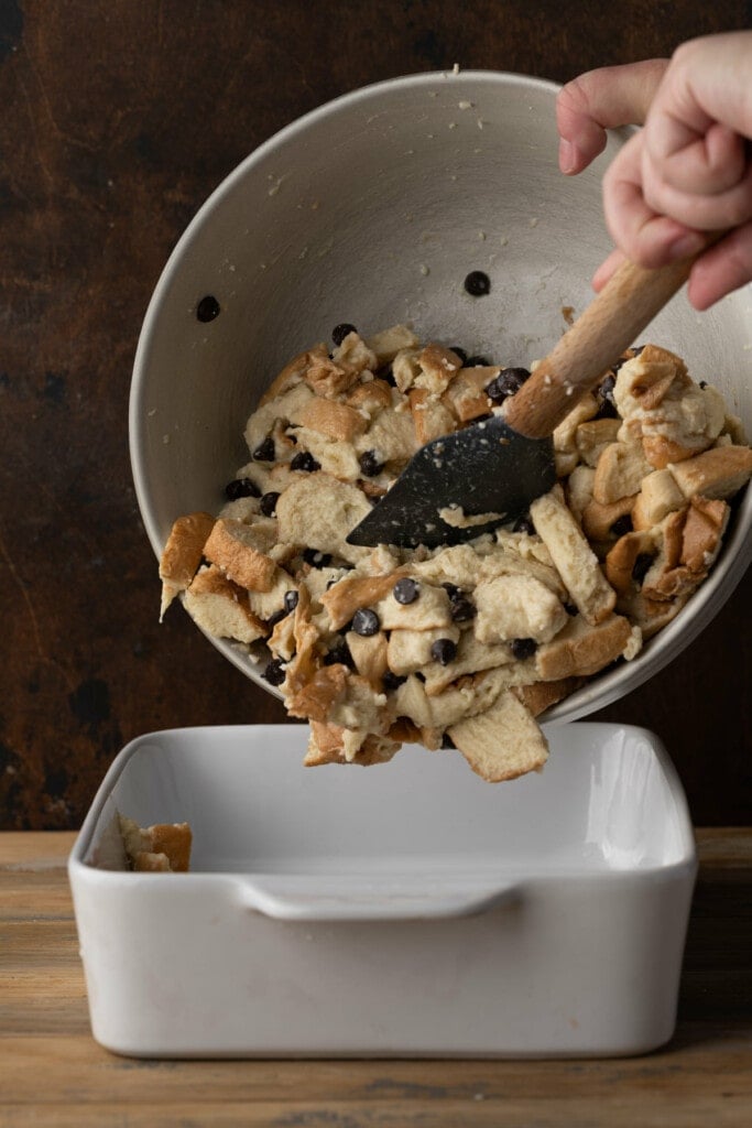 Transferring Bread Pudding with Chocolate Chips to baking dish to bake in the oven