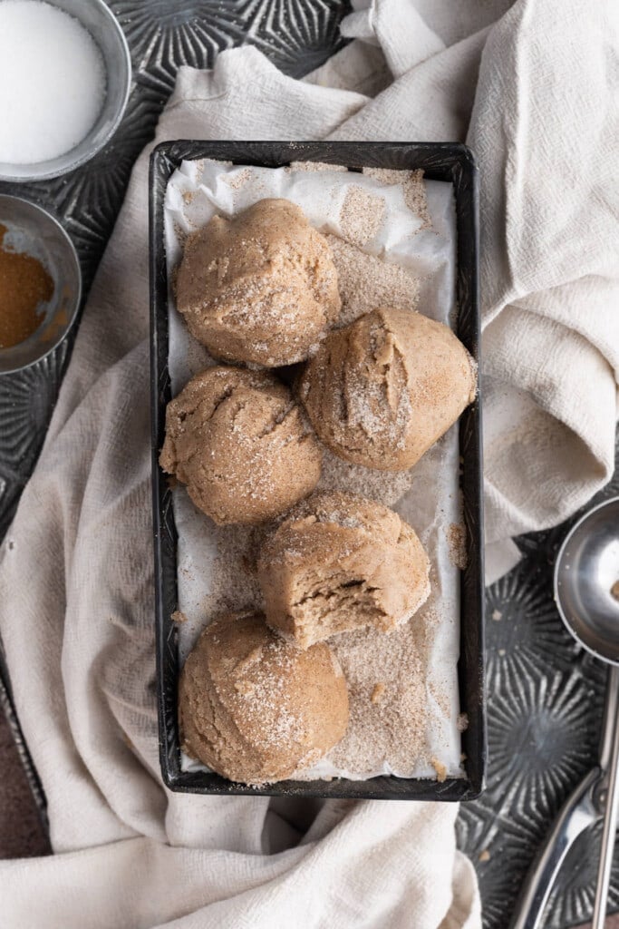 Scoops of Edible Snickerdoodle Cookie Dough with one having a bite taken out