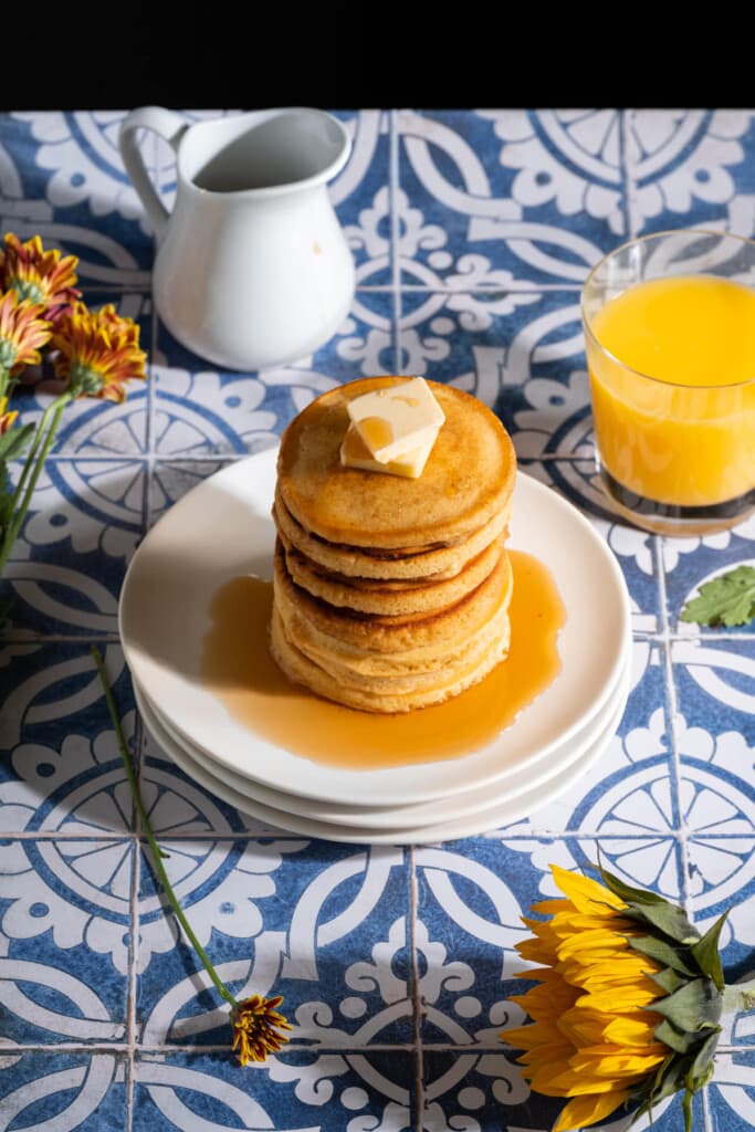 Stack of No Milk Pancakes with a glass of orange juice