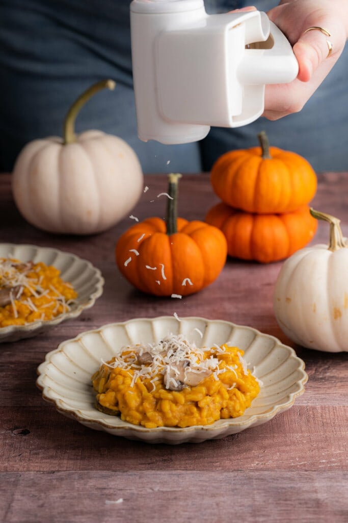 Adding Parmesan cheese to plated Pumpkin and Mushroom Risotto