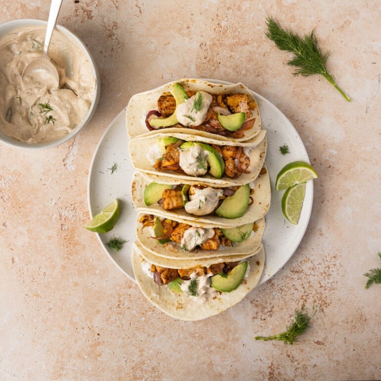 Salmon Tacos with Greek Yogurt Sauce assembled on a large white plate