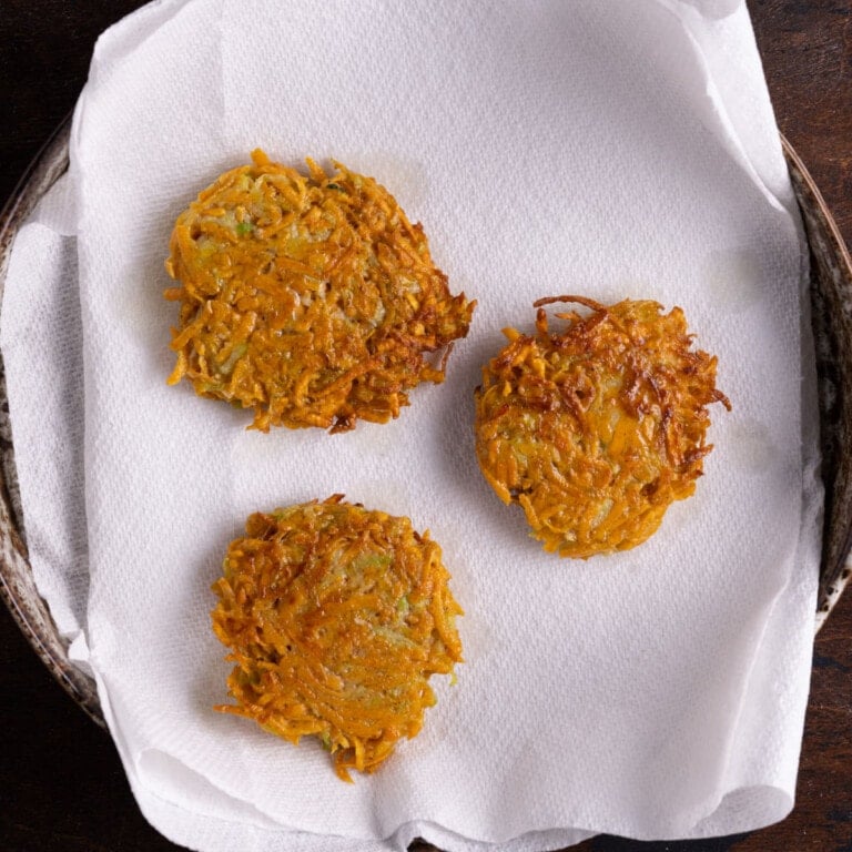 fried sweet potato zucchini fritters on paper towels
