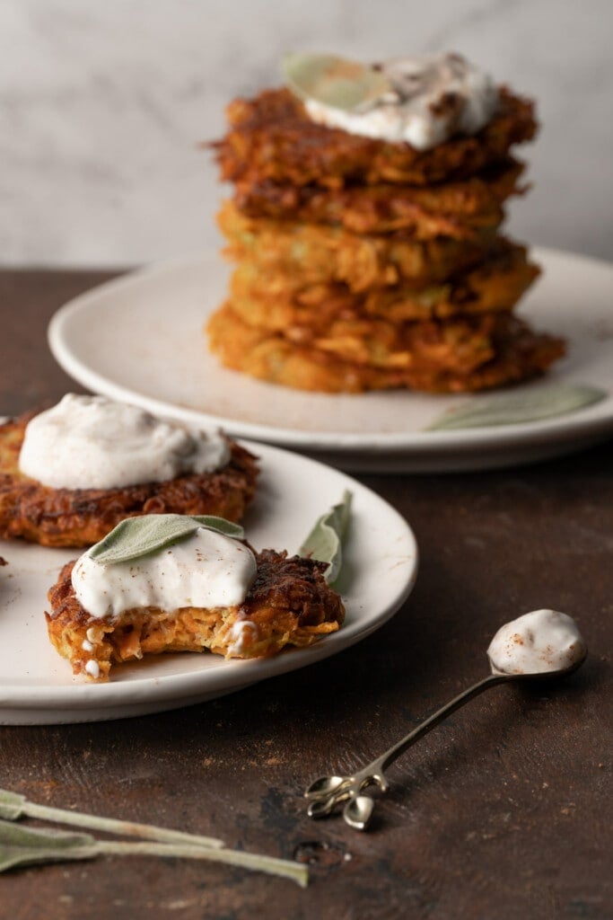 Sweet Potato Zucchini Fritters served on a plate with a bite taken out