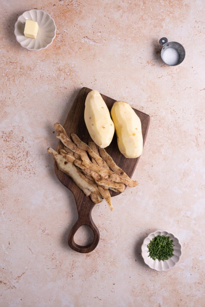 Peeling Russett potatoes to make Truffle Mashed Potatoes.