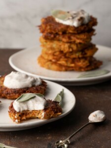 Sweet Potato Zucchini Fritters served on a plate with a bite taken out