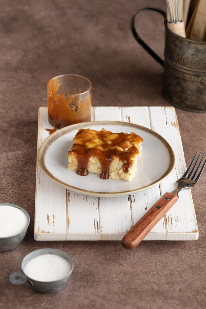 Slice of Bread Pudding with Caramel Sauce with caramel dripping down the side
