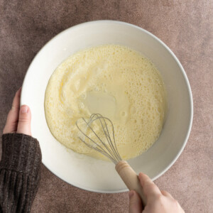 Whisking together wet ingredients for bread pudding