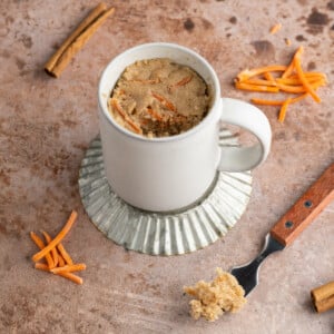 Carrot Mug Cake with forkful taken out and sitting next to it
