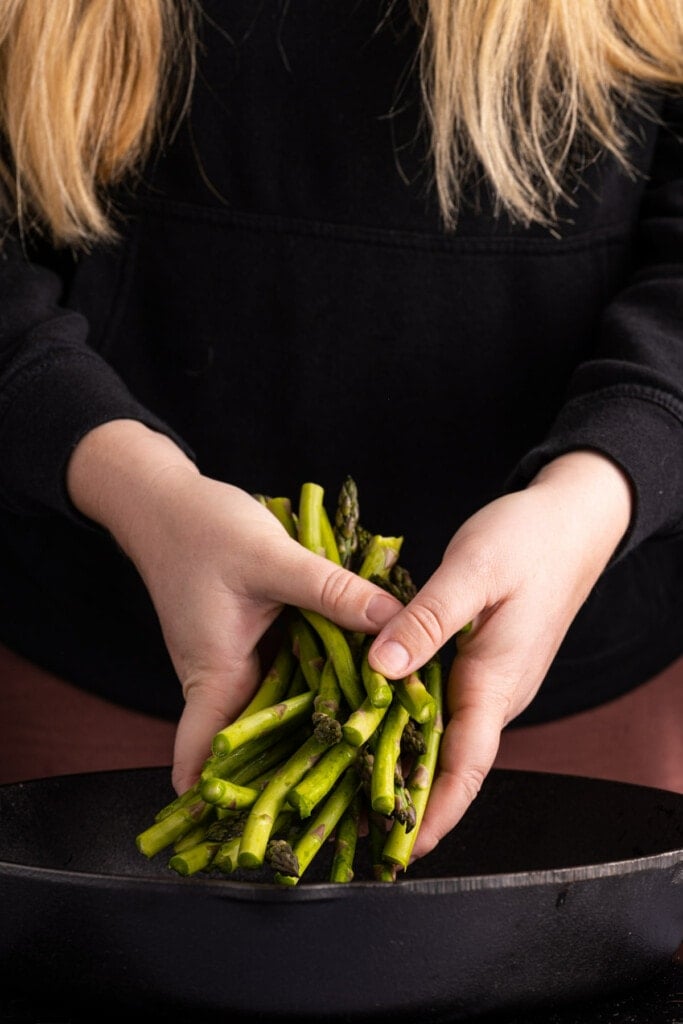 Adding asparagus to a cast-iron skillet