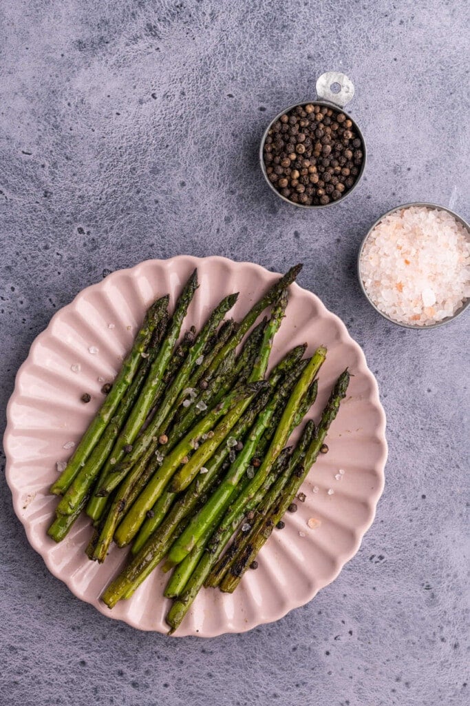 Overhead shot of pink plate with asparagus