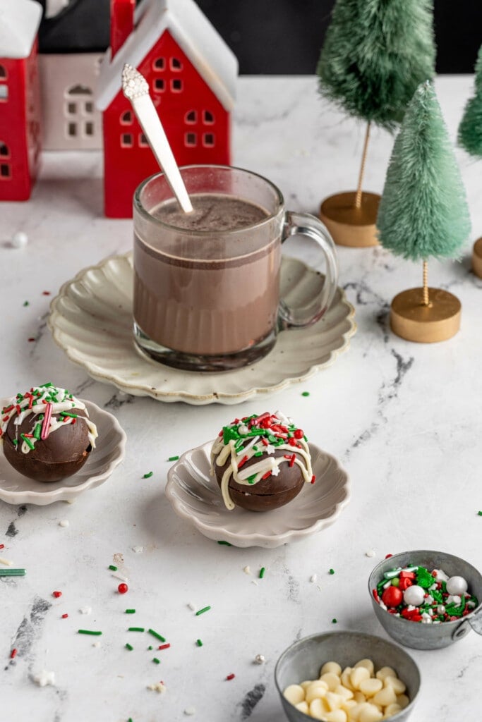 Festive Christmas scene with hot cocoa bombs and a mug of hot chocolate