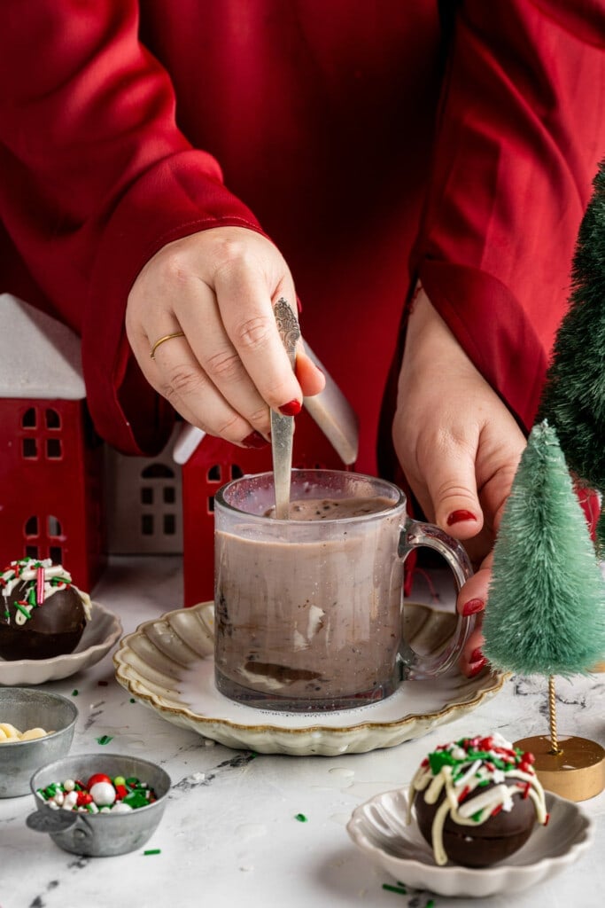 Stirring hot chocolate bomb into hot milk