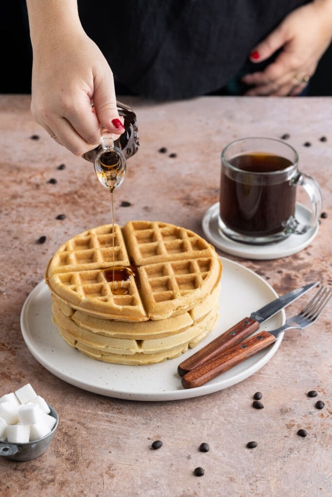 Pouring syrup over waffles without milk