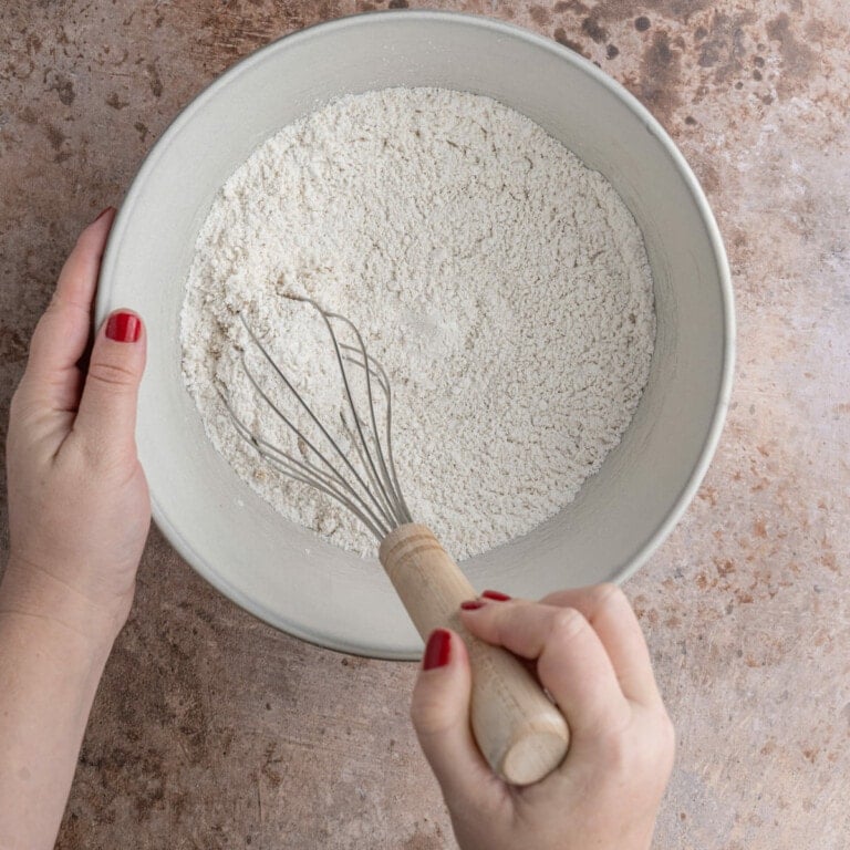 Using a whisk to combine dry ingredients for waffle batter