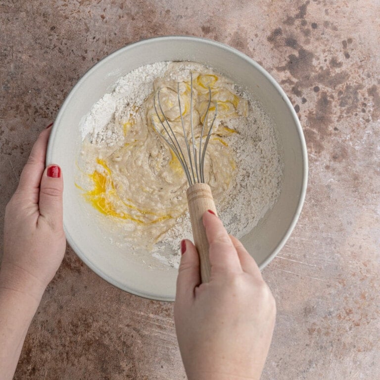 Whisking in the wet ingredients into waffle batter