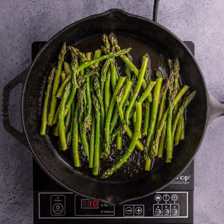 cooking asparagus in a cast-iron skillet