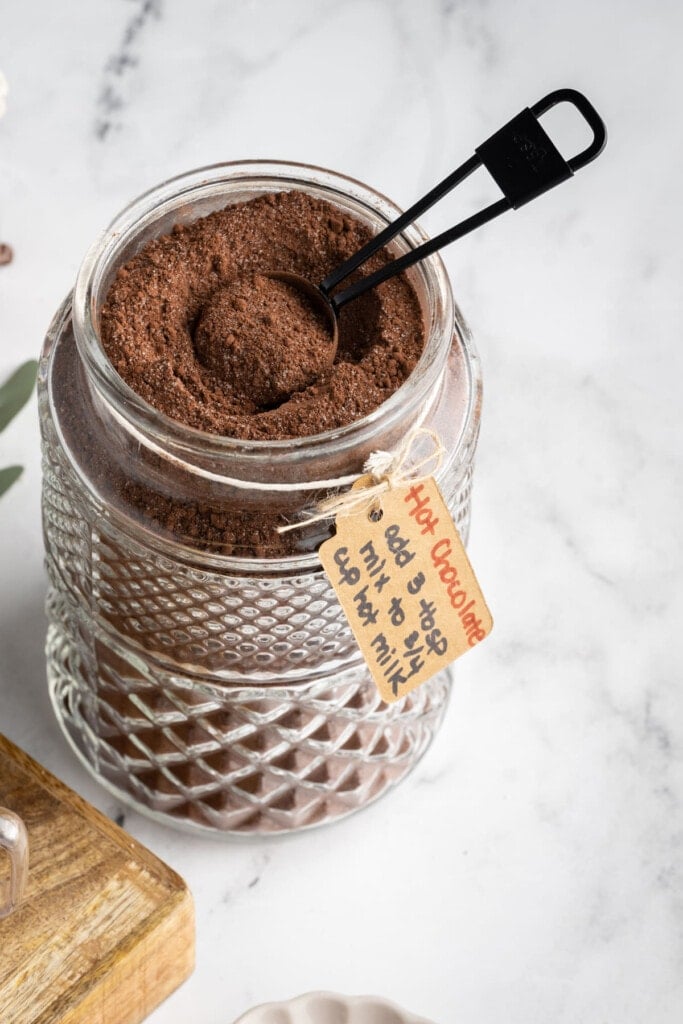 Glass jar with Homemade Hot Cocoa Mix with instructions on how to make it