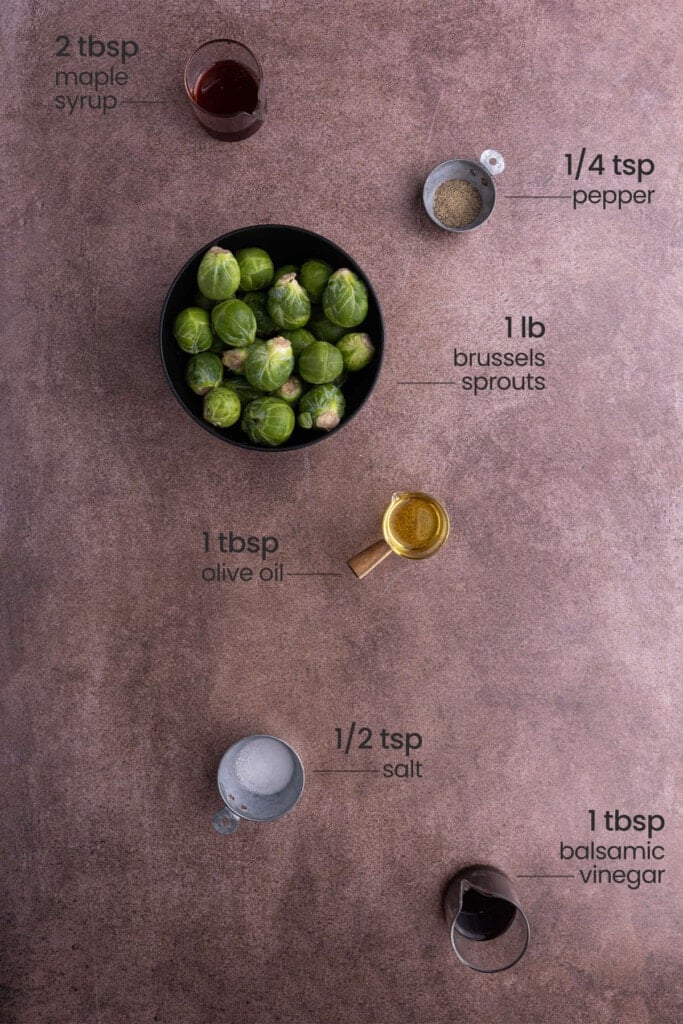 Maple Balsamic Brussels Sprouts ingredients including maple syrup, pepper, brussels sprouts, olive oil, salt, and balsamic vinegar