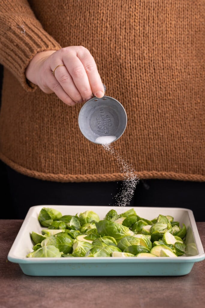 Seasoning brussels sprouts with salt before roasting