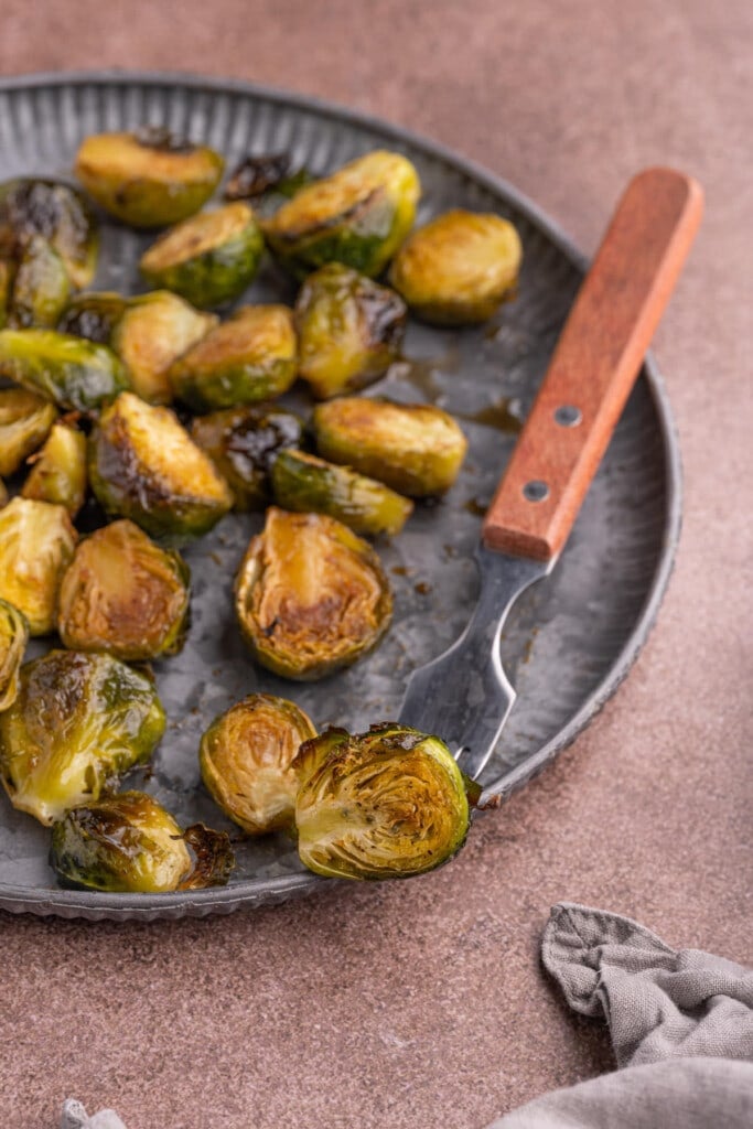 Maple Balsamic Brussels Sprouts with one on a fork