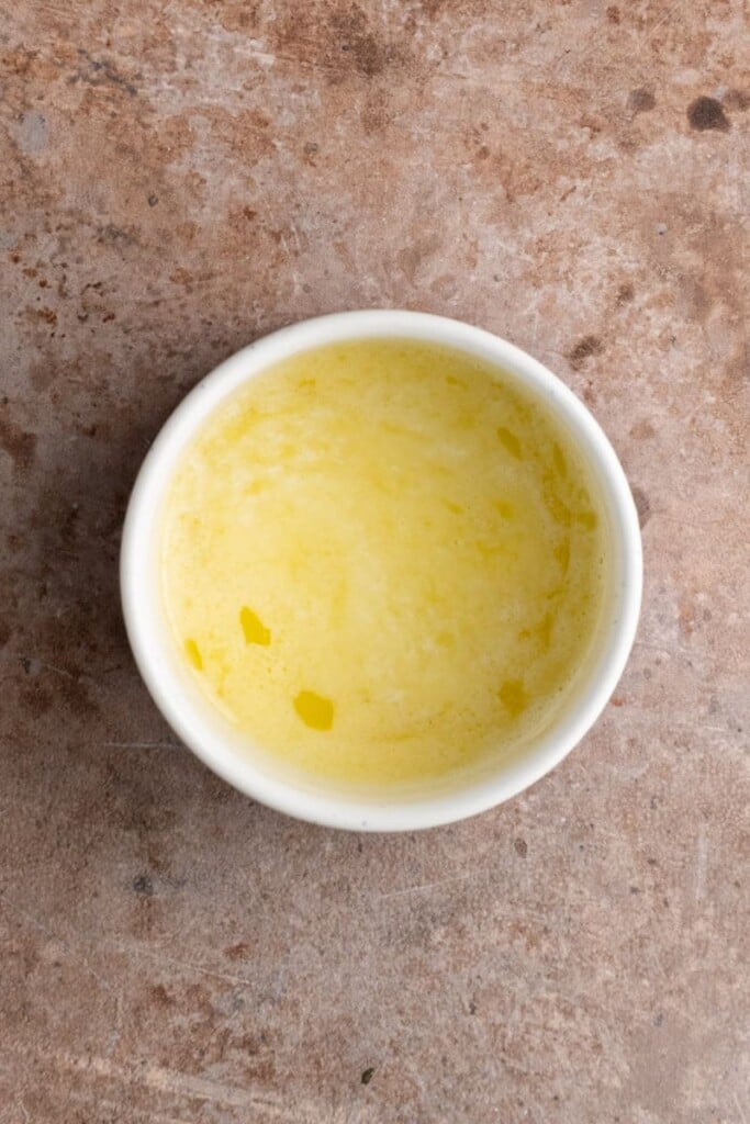 Melted butter cooling to add to carrot cake batter.