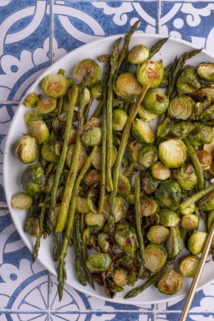 Close up of asparagus and brussels sprouts on platter