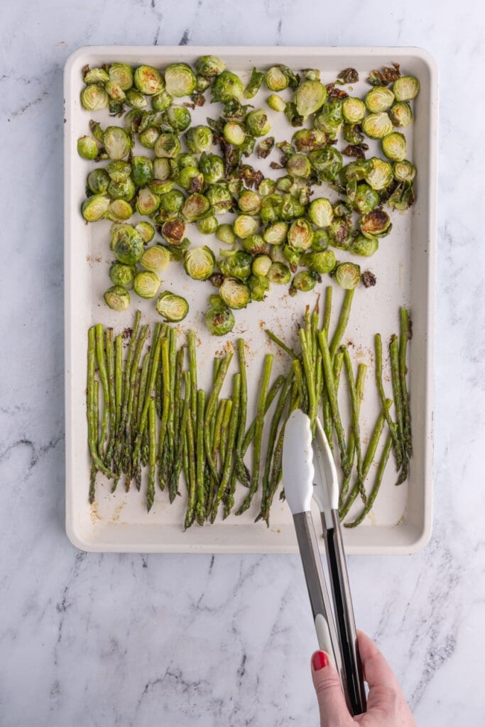 Tossing brussels sprouts and asparagus half way through roasting