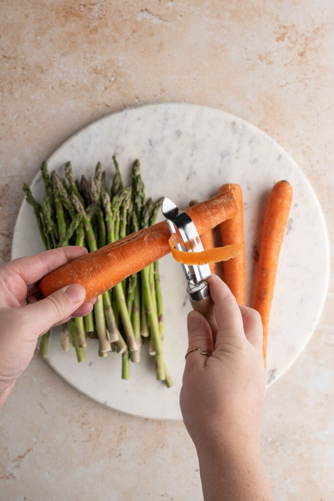 Peeling carrots to roast them