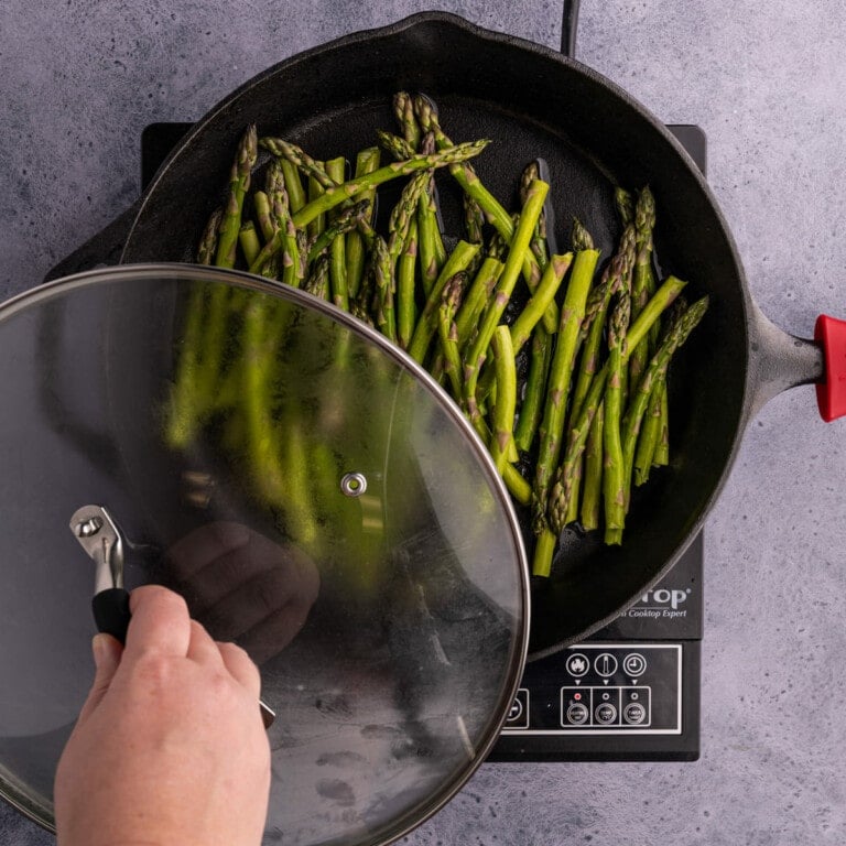 Steaming asparagus in a cast-iron skillet