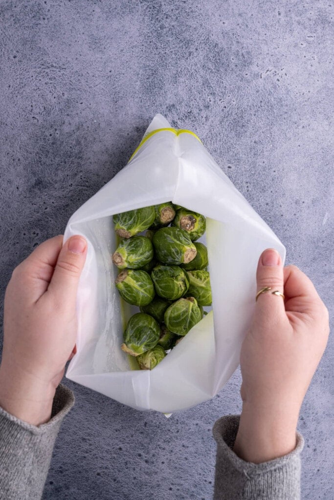 Storing brussels sprouts dry in a reusable storage bag to keep them fresh longer