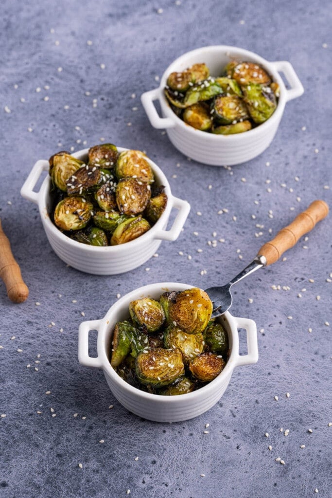 3 servings of brussels sprouts with forks