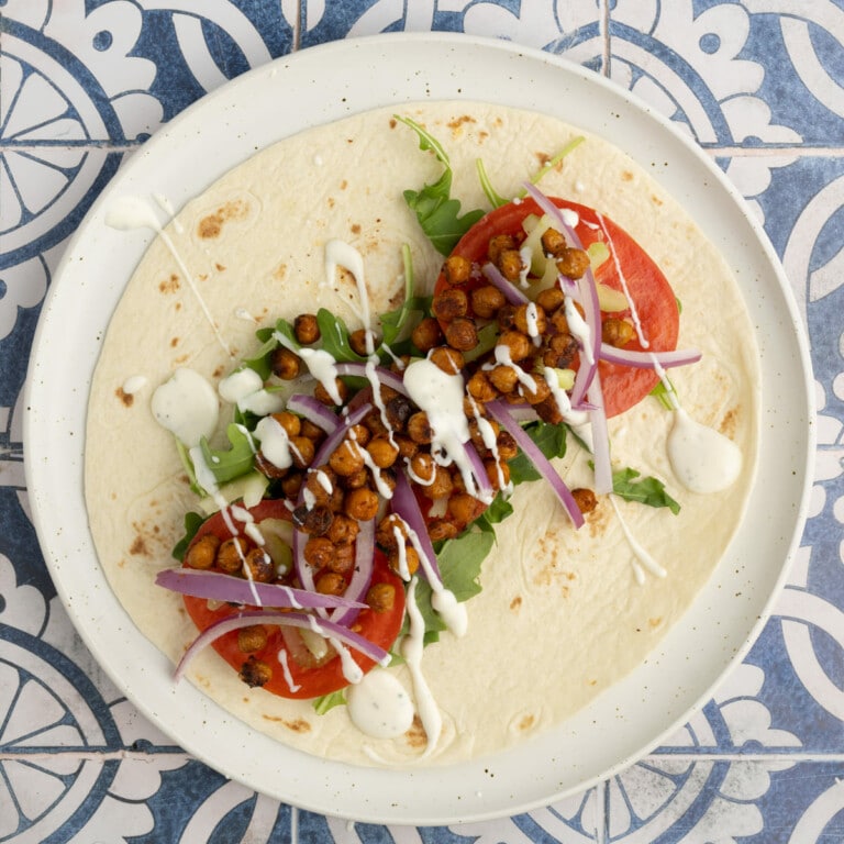 Roasted Buffalo Chickpea Wrap with arugula, tomato, celery, red onion, and ranch dressing