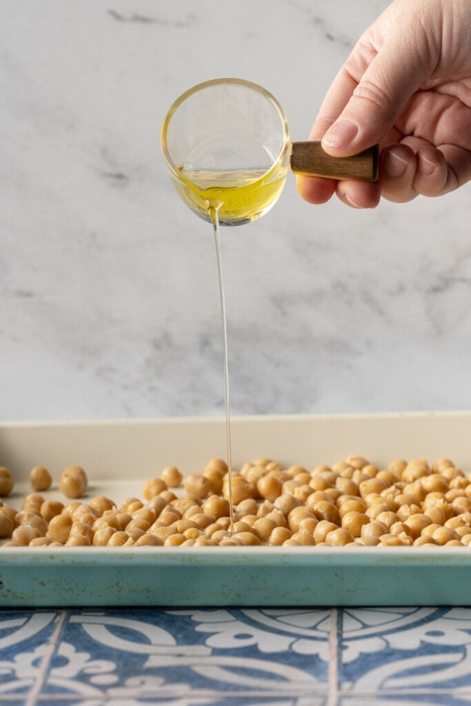 Adding olive oil to prepped chickpeas