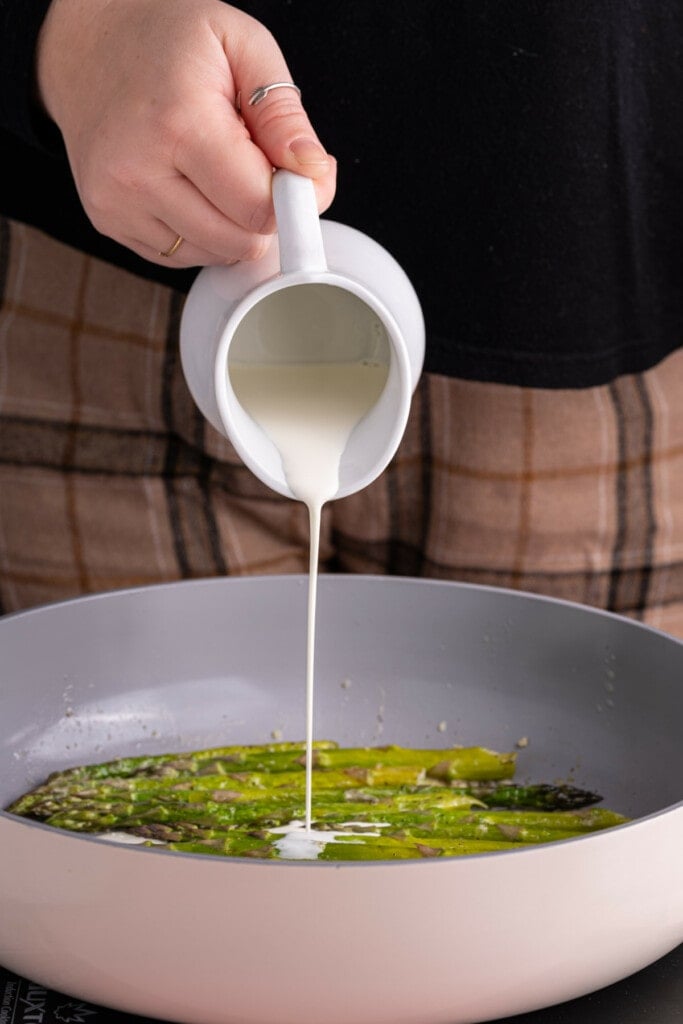 Adding the cream to sauteed asparagus