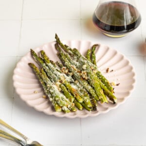 Garlic Parmesan Asparagus on a pink plate