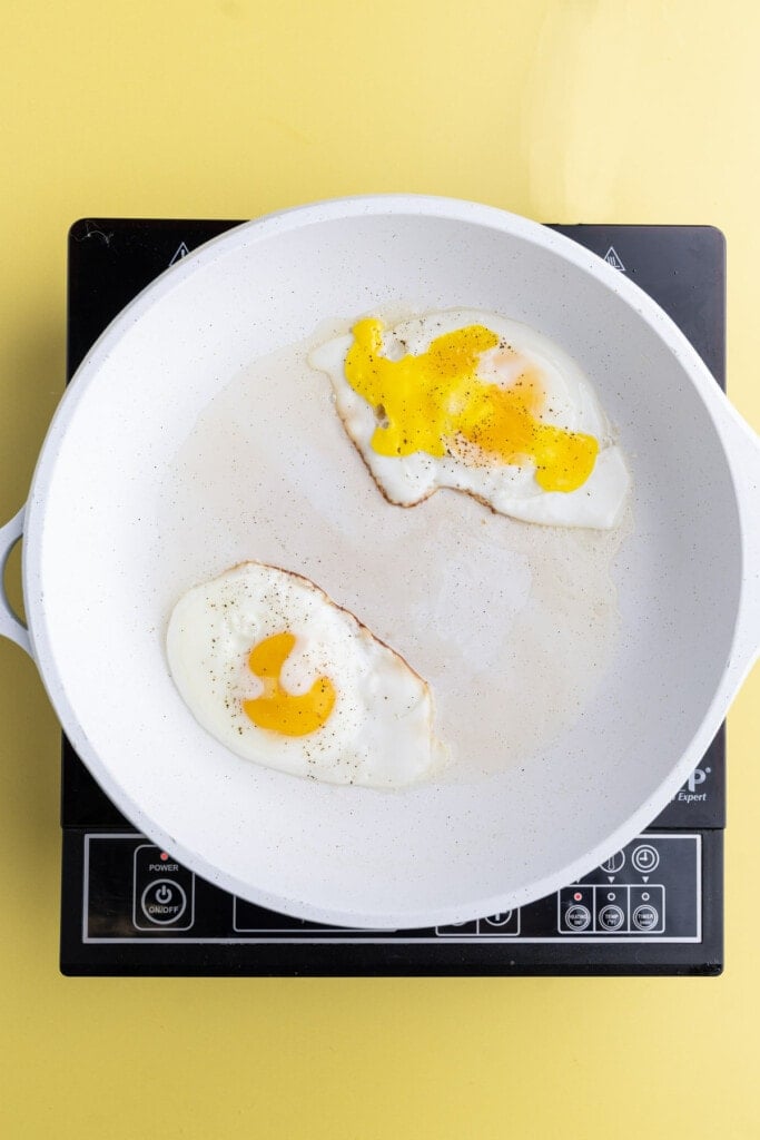 Frying over hard eggs and one with a broken yolk