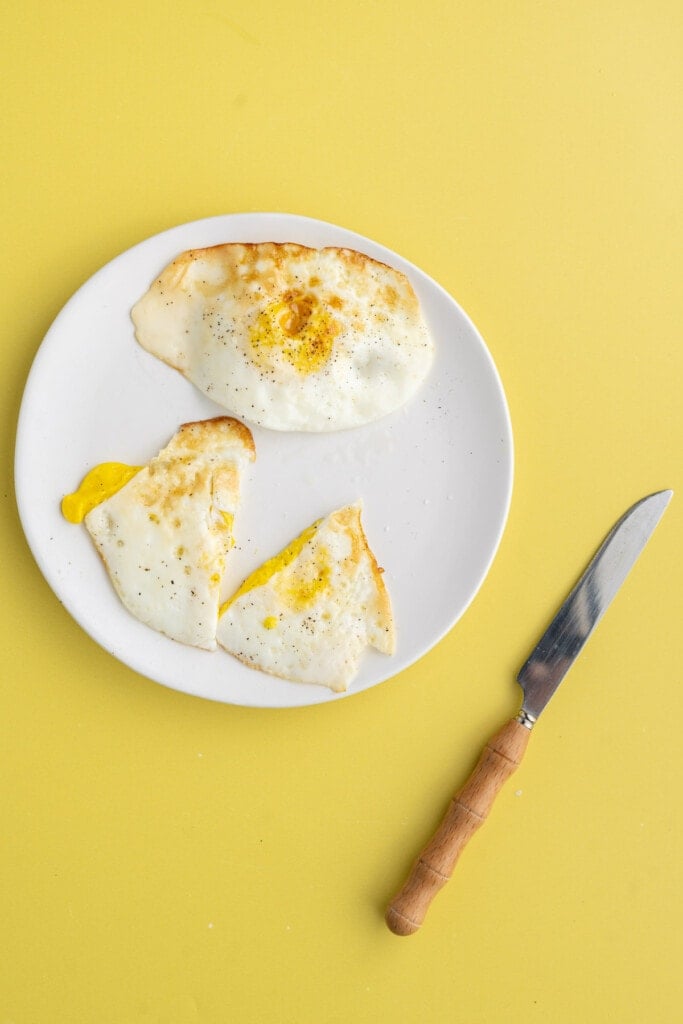 Two over hard eggs with one being cut in half