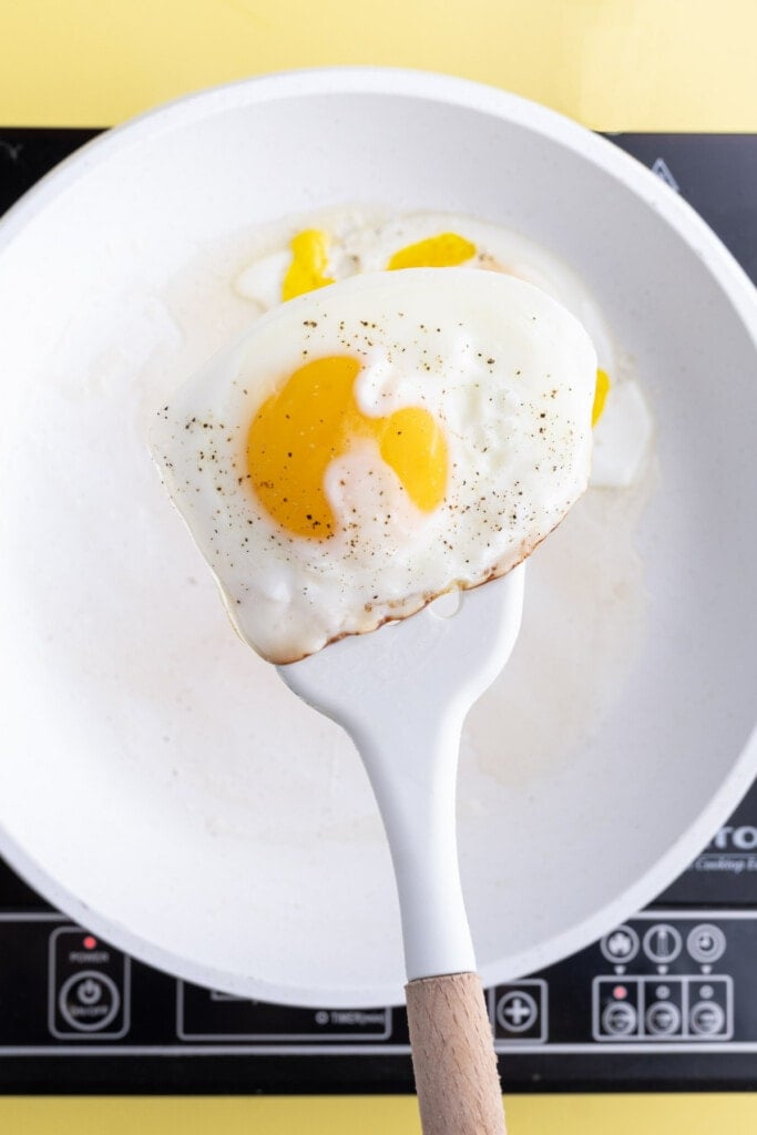 Using a spatula to flip eggs