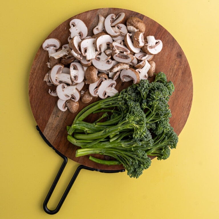 Overhead shot of prepped broccolini and mushrooms