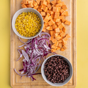 frozen corn, black beans drained and rinsed from the can, cubed sweet potato, and sliced red onion