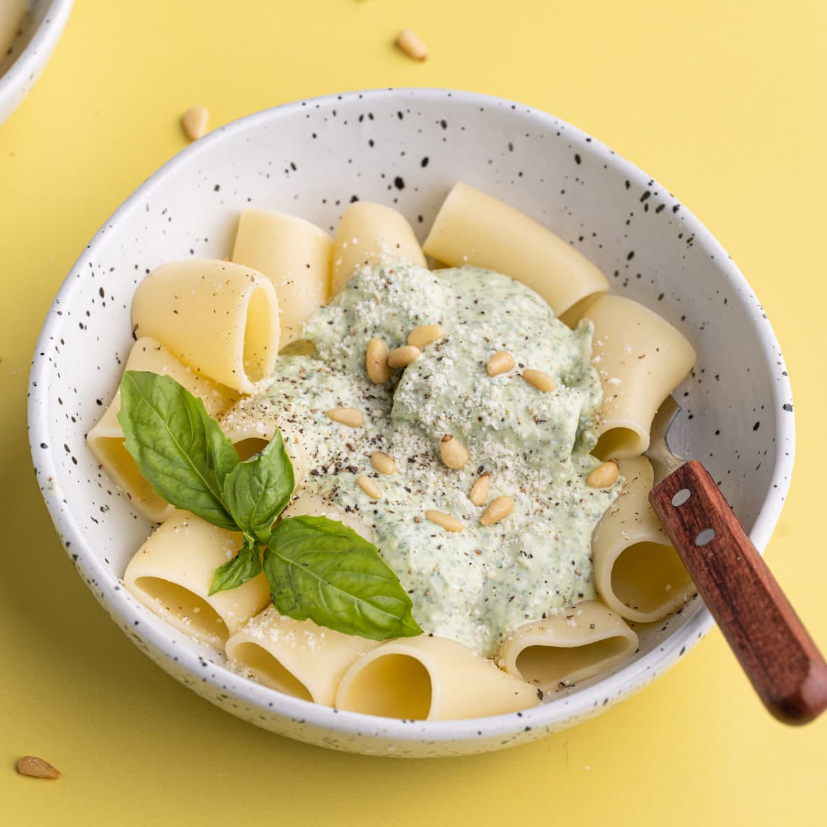 Bowl of Ricotta Pesto Pasta with a fork