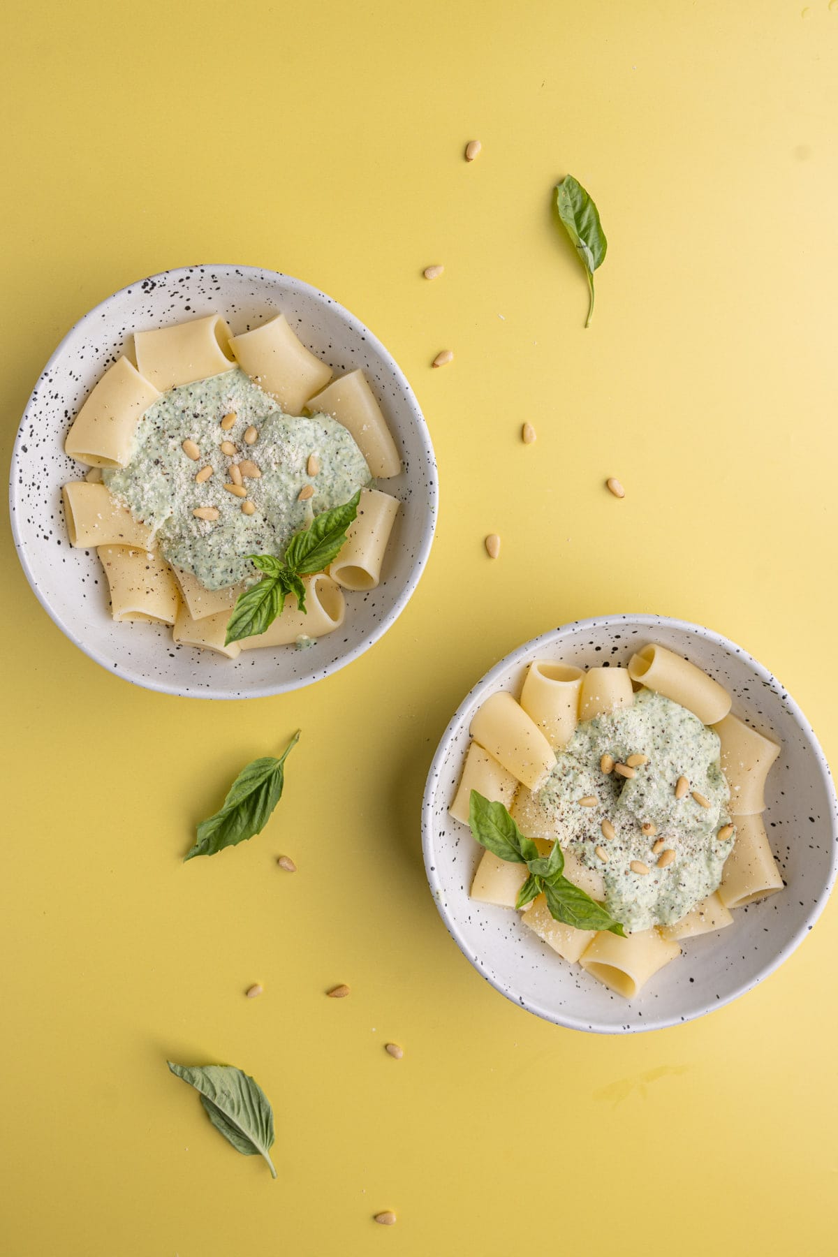 Overhead image of two plates of Ricotta Pesto Pasta