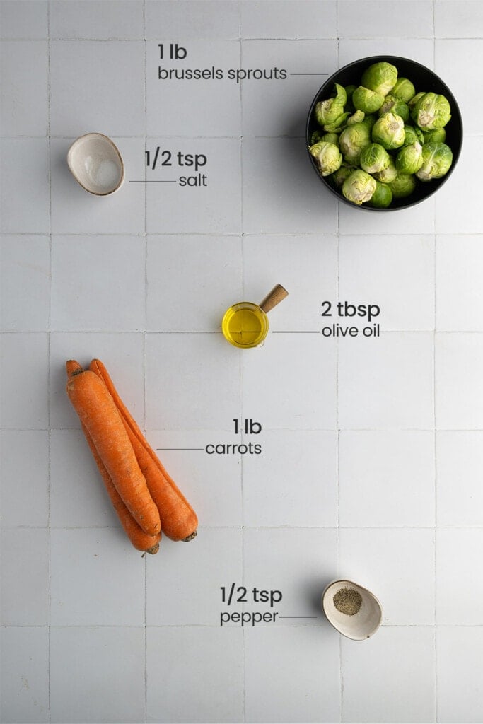 All ingredients for Roasted Brussels Sprouts and Carrots including brussels sprouts, carrots, olive oil, salt, and pepper