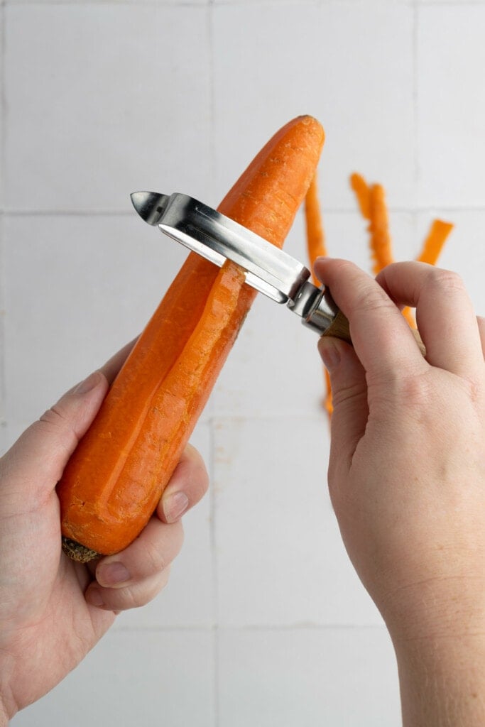 Peeling carrots before roasting